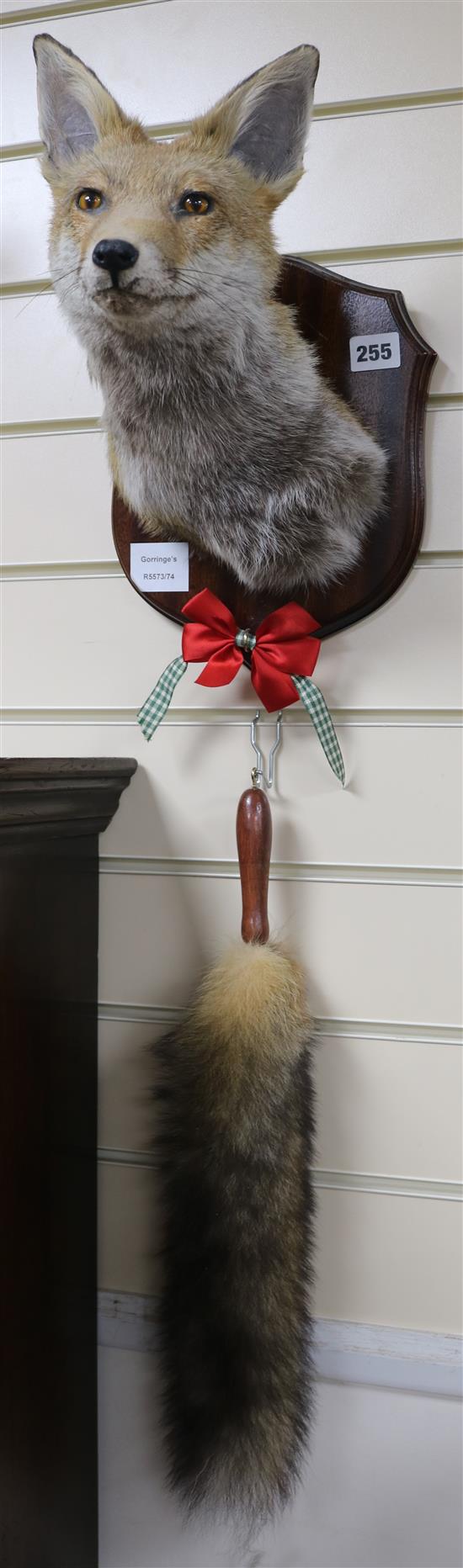 A taxidermic fox and brush, on plaque